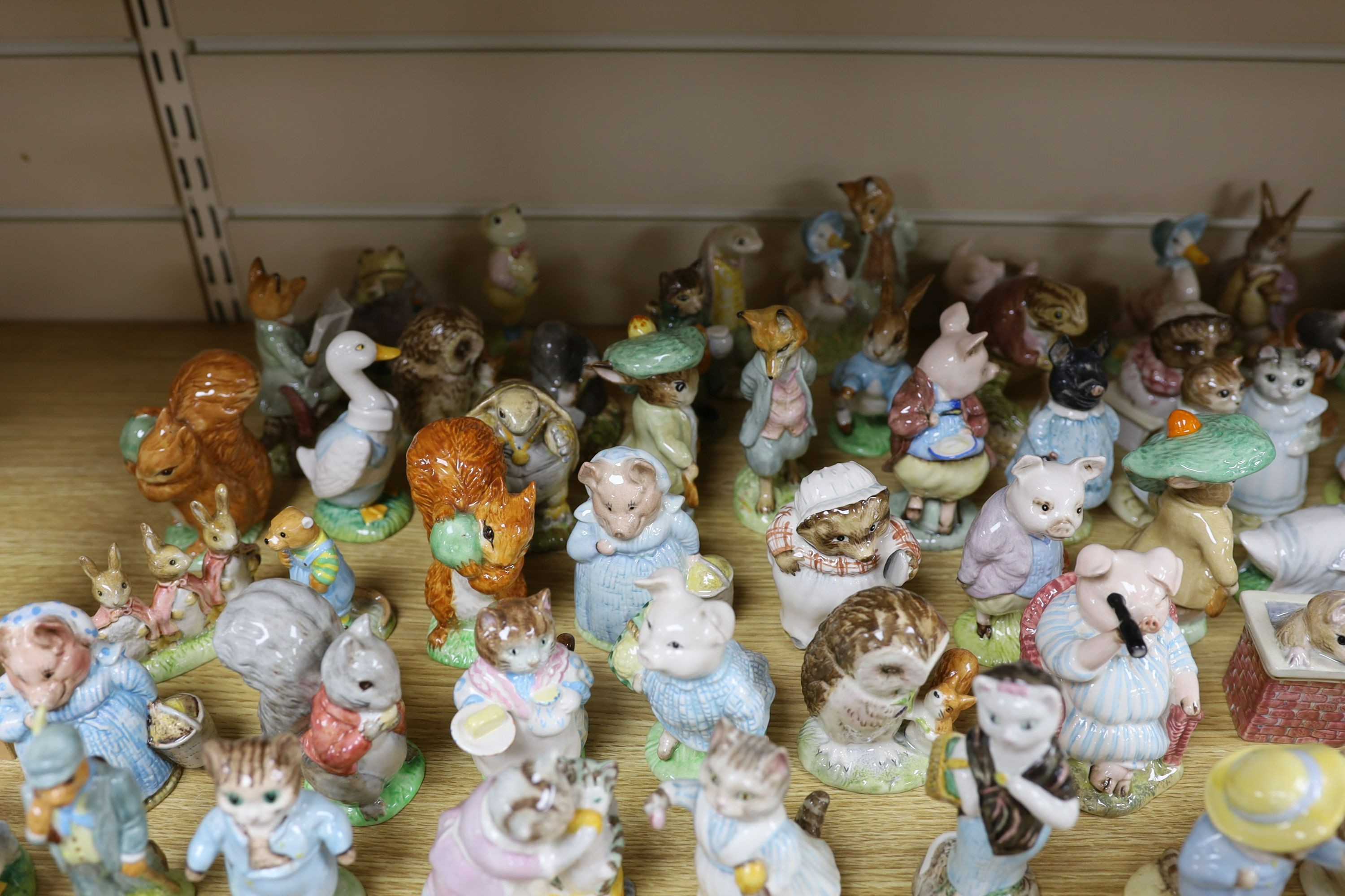 A large collection of Beatrix Potter ceramic figures by Royal Doulton, Beswick and Royal Albert, to include ‘Sir Isaac Newton’ and ‘Mr McGregor’